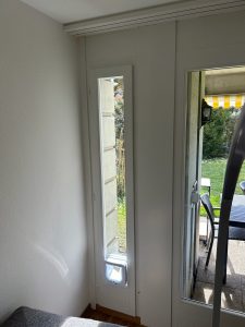 Cat door fitted into a full-height glazed door