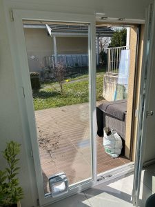 Cat door fitted low in a glazed patio door