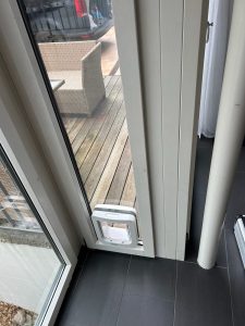 Cat door fitted into a living room balcony door